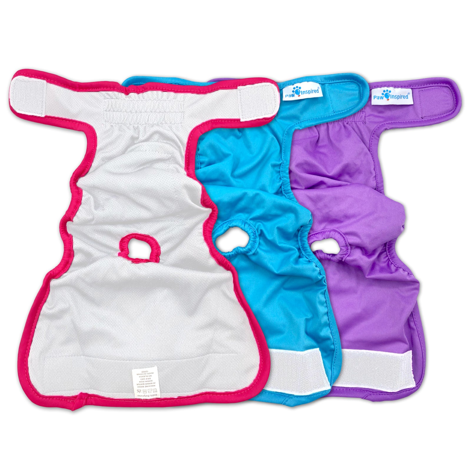 Interior view of three Paw Inspired reusable dog diapers in red, blue, and purple, laid flat to show tail hole and inner lining.