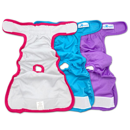 Interior view of three Paw Inspired reusable dog diapers in red, blue, and purple, laid flat to show tail hole and inner lining.