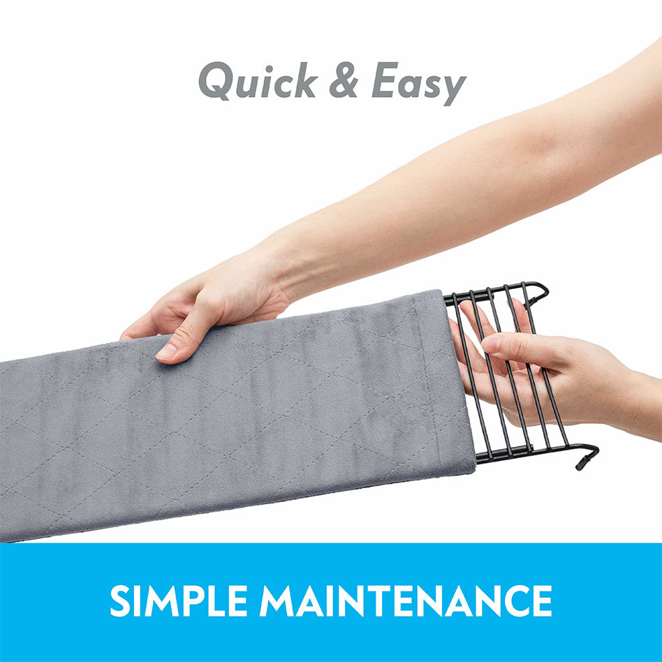 Hands sliding a Paw Inspired Exit Ramp fleece cover onto a wire ramp, showcasing simple maintenance.