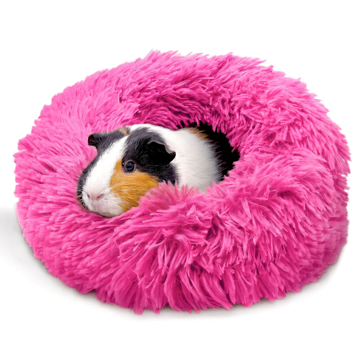 A cute tricolor guinea pig resting comfortably inside a bright pink Paw Inspired Furr-O plush burrowing pet bed.
