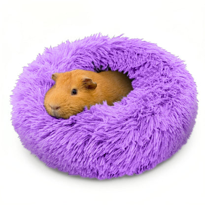 A cute brown guinea pig burrowed comfortably inside a purple Paw Inspired Furr-O plush pet bed.