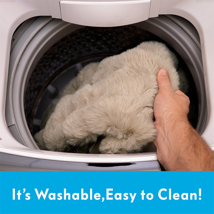 Demonstration of Paw Inspired waterproof pet blanket being placed into a washing machine for easy cleaning.