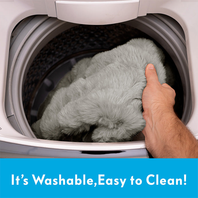 Demonstration of Paw Inspired waterproof pet blanket being placed into a washing machine for easy cleaning.