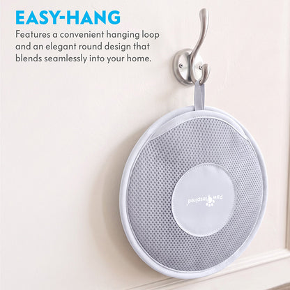 The Paw Inspired Electrostatic Pet Hair Removal Glove hanging neatly on a silver wall hook using its convenient integrated hanging loop.