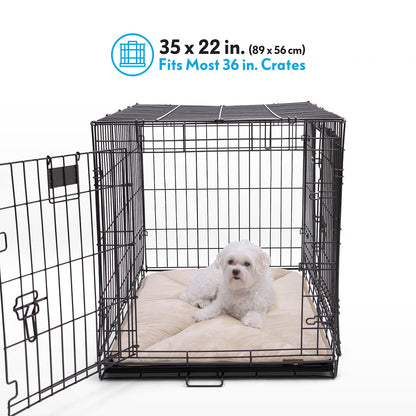 A Shetland Sheepdog resting on a tan Paw Inspired self-heating crate liner measuring 35 by 22 inches inside a 36-inch wire crate.