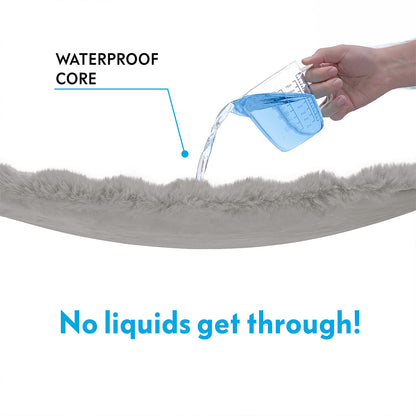 Close-up of Paw Inspired Waterproof Core technology showing liquid being poured onto the faux fur blanket without leaking through.