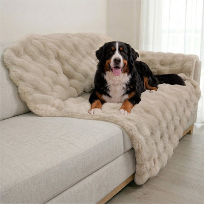 A Bernese Mountain Dog resting on a Paw Inspired extra-large tan waterproof faux fur blanket (60x80 in) used as a heavy-duty sofa protector.