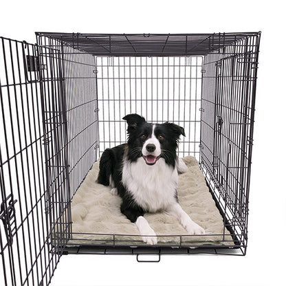 A Border Collie lying comfortably on a Paw Inspired large tan waterproof faux fur blanket (50x60 in) used as a protective and cozy dog crate mat.