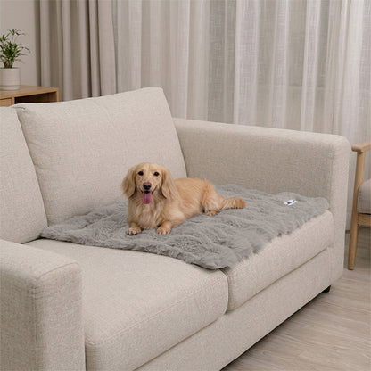 Paw Inspired Waterproof Dog Blanket for couch and sofa protection featuring a long-haired dog resting on a plush grey mat.